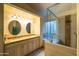 Elegant bathroom featuring double sinks, granite countertops, and a glass-enclosed shower at 10527 E Acacia Dr, Scottsdale, AZ 85255