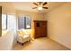 Comfortable bedroom featuring carpet, an accent chair, and natural light at 10527 E Acacia Dr, Scottsdale, AZ 85255