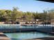 Inviting community pool area with comfortable lounge chairs and desert landscape at 10527 E Acacia Dr, Scottsdale, AZ 85255