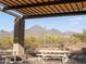 Covered picnic area with tables, offering a beautiful view of the desert landscape and mountains at 10527 E Acacia Dr, Scottsdale, AZ 85255