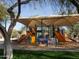 Shaded playground with slides, climbing structures, and educational signage for outdoor fun at 10527 E Acacia Dr, Scottsdale, AZ 85255