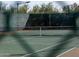 Well-maintained tennis court with a net and green surface, perfect for recreational play and exercise at 10527 E Acacia Dr, Scottsdale, AZ 85255