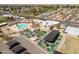 Wide aerial view of recreation center with mini golf, pool, parking, and nearby homes and streets at 10860 W Cheryl Dr, Sun City, AZ 85351