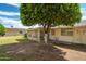 Backyard featuring mature trees, patio area, and a screened-in porch at 10860 W Cheryl Dr, Sun City, AZ 85351