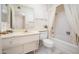 Well-lit bathroom features vanity, toilet, and shower with curtain at 10860 W Cheryl Dr, Sun City, AZ 85351