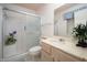 Modern bathroom features walk-in shower, vanity, and mirror at 10860 W Cheryl Dr, Sun City, AZ 85351