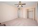 Bedroom features carpet, ceiling fan, and closet at 10860 W Cheryl Dr, Sun City, AZ 85351