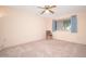 Bedroom features carpet, ceiling fan, and one window at 10860 W Cheryl Dr, Sun City, AZ 85351