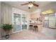 View of the dining area with barstool seating, and sliding glass door to the screened patio at 10860 W Cheryl Dr, Sun City, AZ 85351