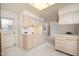 Open kitchen with bright lighting, and white tiled floors at 10860 W Cheryl Dr, Sun City, AZ 85351