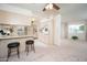 Eat-in kitchen with breakfast bar and tiled floors open to dining area at 10860 W Cheryl Dr, Sun City, AZ 85351