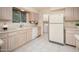 Bright kitchen with white appliances and tiled floors at 10860 W Cheryl Dr, Sun City, AZ 85351