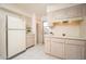 Kitchen with white appliances and pantry at 10860 W Cheryl Dr, Sun City, AZ 85351