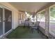 View of the enclosed lanai with two chairs, screened windows and backyard views at 10860 W Cheryl Dr, Sun City, AZ 85351