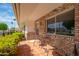 A cozy brick-paved patio with seating offers a charming outdoor space at 10860 W Cheryl Dr, Sun City, AZ 85351
