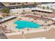 Aerial view of a swimming pool with lounge chairs surrounded by palm trees at the recreation center at 10860 W Cheryl Dr, Sun City, AZ 85351
