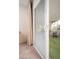 Open sliding glass door with vertical blinds leading to the screened lanai at 10860 W Cheryl Dr, Sun City, AZ 85351