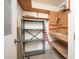 Functional storage room with shelving and workbench at 10860 W Cheryl Dr, Sun City, AZ 85351