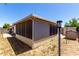 Exterior view of a screened-in patio structure with a metal roof and surrounding landscaping at 1116 S 53Rd St, Mesa, AZ 85206