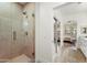 Contemporary bathroom featuring a glass-enclosed shower and a view into a sunlit bedroom at 11500 E Cochise Dr # 1015, Scottsdale, AZ 85259