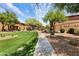 Scenic walkway on lush grounds through community with manicured grass at 11500 E Cochise Dr # 1015, Scottsdale, AZ 85259