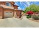 Exterior view of building with garage, driveway, and beautifully landscaped yard at 11500 E Cochise Dr # 1015, Scottsdale, AZ 85259