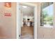 Inviting front entry showcasing modern door, neutral stucco and a glimpse of the home's open-concept interior at 11500 E Cochise Dr # 1015, Scottsdale, AZ 85259