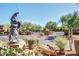 View of the decorative equestrian statue and gated entrance to the community at 11500 E Cochise Dr # 1015, Scottsdale, AZ 85259