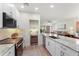 Contemporary kitchen with stainless steel appliances, granite countertops, and an open layout to the living area at 11500 E Cochise Dr # 1015, Scottsdale, AZ 85259