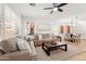 Cozy living room with neutral palette, comfortable sofas, a ceiling fan, and natural light, perfect for relaxation at 11500 E Cochise Dr # 1015, Scottsdale, AZ 85259