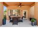 Inviting outdoor patio with ceiling fan, table, chairs, and neat decor at 11500 E Cochise Dr # 1015, Scottsdale, AZ 85259