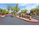 Community sign for Minage Crossing with attractive desert landscaping at 11500 E Cochise Dr # 1015, Scottsdale, AZ 85259