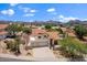 Aerial view of a home with red tiled roof, desert landscaping and a three car garage at 1221 E Claire Dr, Phoenix, AZ 85022
