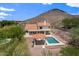 Aerial view of backyard with a pool, outdoor pavilion, desert landscaping, and mountain views at 1221 E Claire Dr, Phoenix, AZ 85022