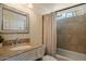 Bathroom features a neutral vanity, a large mirror, and a bathtub with shower at 1221 E Claire Dr, Phoenix, AZ 85022