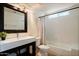 Bathroom featuring a modern vanity, toilet, tub with shower, and neutral color scheme at 1221 E Claire Dr, Phoenix, AZ 85022