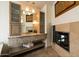 Bathroom with granite counters, a fireplace, custom cabinets and an open vanity at 1221 E Claire Dr, Phoenix, AZ 85022