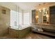 Bathroom features a bathtub with glass block window, granite counters, and modern lighting at 1221 E Claire Dr, Phoenix, AZ 85022