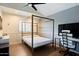 Bedroom with hard floors and a four-post bed frame at 1221 E Claire Dr, Phoenix, AZ 85022