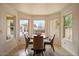 Bright breakfast nook featuring a round table, 4 chairs, tile flooring, and three large windows at 1221 E Claire Dr, Phoenix, AZ 85022