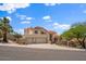 Beautiful two-story home featuring a three-car garage, tile roof, and well-manicured desert landscaping at 1221 E Claire Dr, Phoenix, AZ 85022