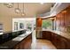 Open kitchen features stone countertops, an island with seating, and lots of cabinet storage at 1221 E Claire Dr, Phoenix, AZ 85022