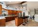 Spacious kitchen featuring stone countertops, an island with seating, and modern stainless-steel appliances at 1221 E Claire Dr, Phoenix, AZ 85022