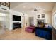 Living room showcasing tile flooring, a ceiling fan, and a modern fireplace at 1221 E Claire Dr, Phoenix, AZ 85022