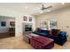 Living room showcasing tile flooring, a ceiling fan, and a modern fireplace at 1221 E Claire Dr, Phoenix, AZ 85022
