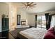Bright bedroom features a fireplace, dark wood floors, ceiling fan, and access to an outdoor balcony at 1221 E Claire Dr, Phoenix, AZ 85022