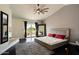 Main bedroom showcasing a fireplace, hardwood floors, a ceiling fan, and backyard access at 1221 E Claire Dr, Phoenix, AZ 85022
