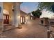 Inviting outdoor space with a brick fireplace, lush greenery, pavers, and a cozy ambiance at 1221 E Claire Dr, Phoenix, AZ 85022