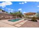 Private backyard featuring a sparkling pool, relaxing gazebo, and desert landscaping at 1221 E Claire Dr, Phoenix, AZ 85022