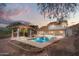Resort-style pool and covered patio with a mountain backdrop, perfect for outdoor entertaining at 1221 E Claire Dr, Phoenix, AZ 85022